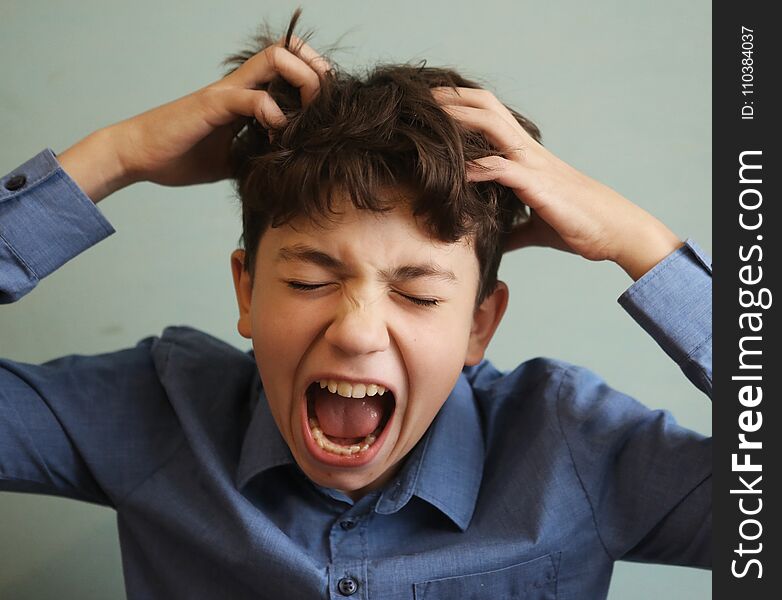 Preteen handsome boy scratch his head itch because of lice invasion