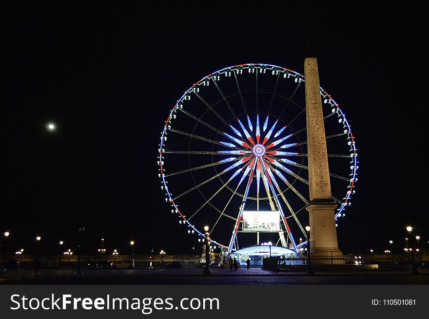 Photo of London Eye, London Near Brown Concrete Monument during Night Time
