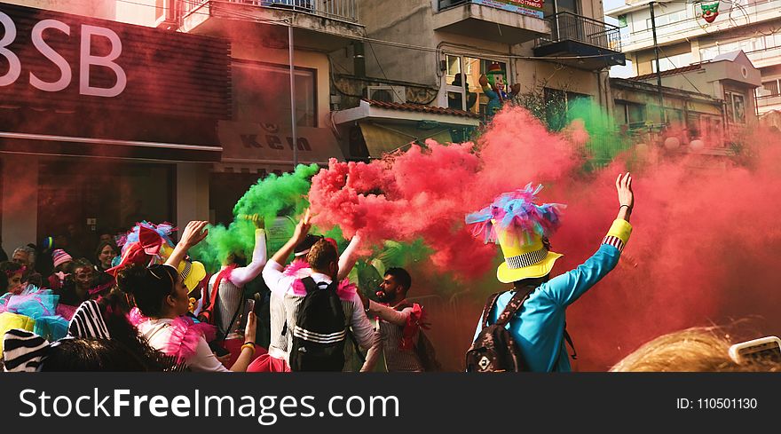 People Spraying Assorted Color Of Smoke