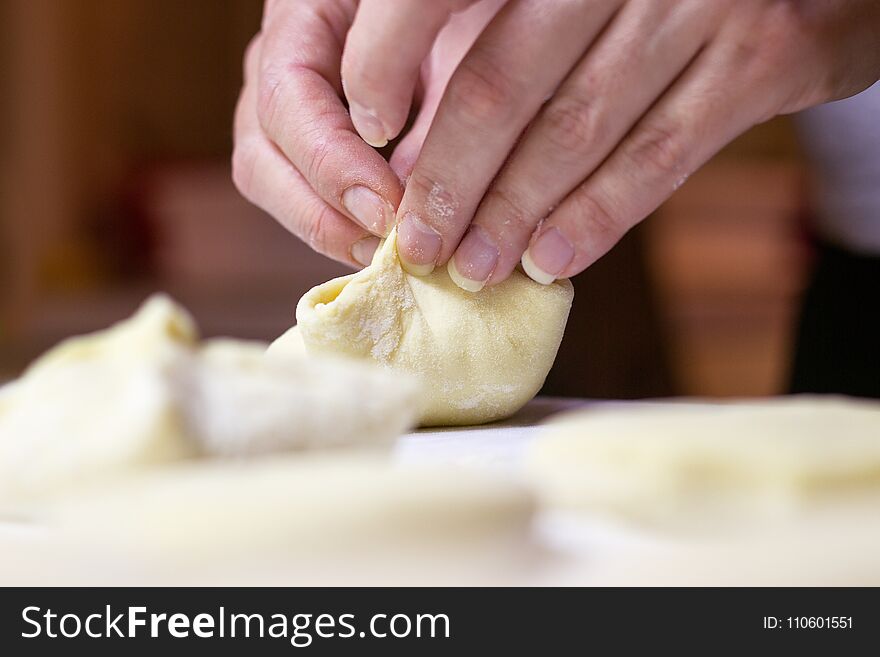 Beautiful woman hands making dough