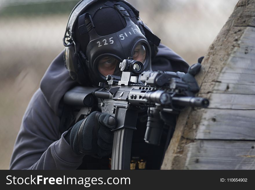 Person Holding Airsoft Gun in Shallow Focus Lens