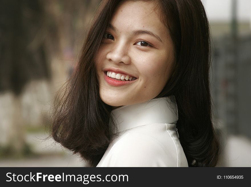 Smiling Woman Wearing White Turtleneck Top