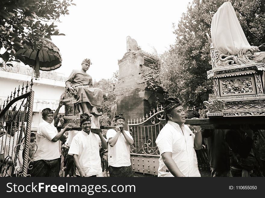 Men Carrying People on Their Seats