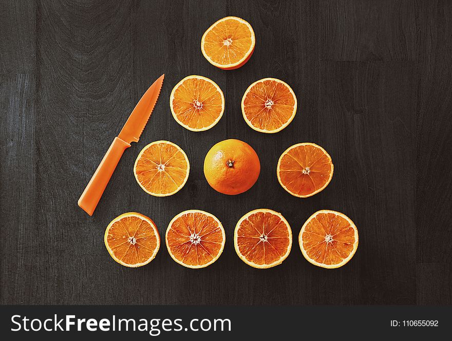 Sliced Orange Fruit With Knife