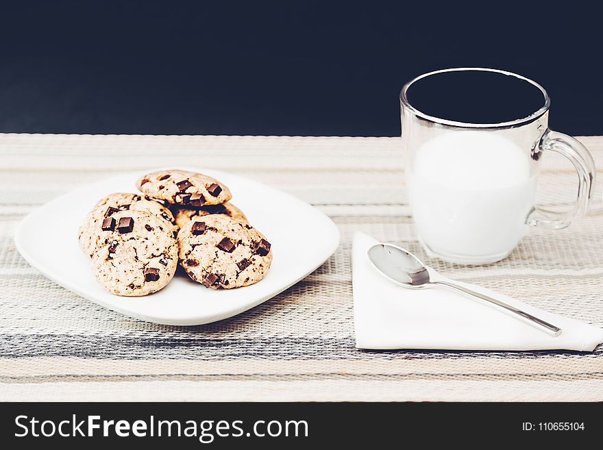 Photo Of Clear Mug Beside Plate With Cookies