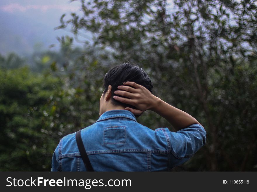 Person In Blue Denim Jacket