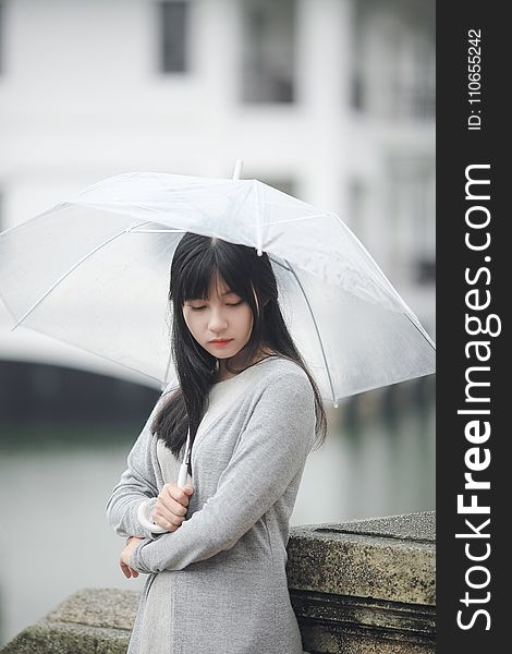 Woman Wearing Gray Sweater Holding Clear Umbrella