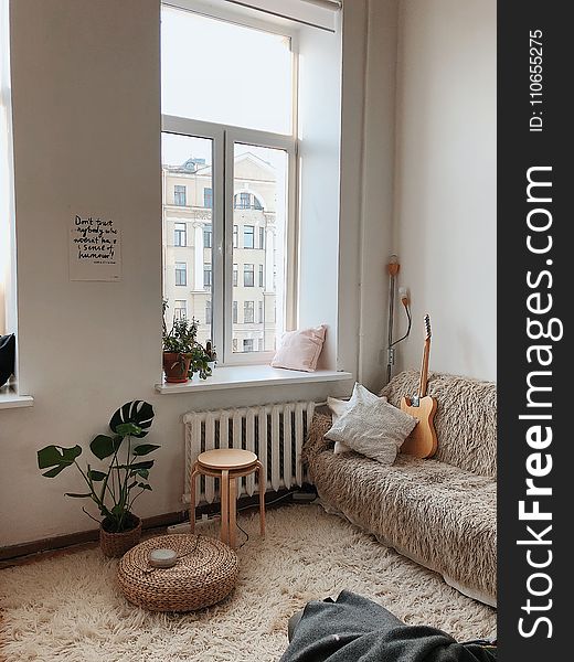 Round Brown Wooden Stool Near Brown Sofa