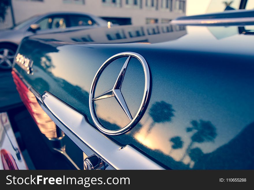 Close Up Photography of Chrome Mercedes-benz Car Emblem