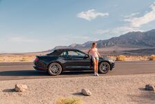 Young Girl Standing By The Black Ford Mustang GT Stock Image