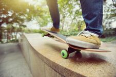 Skateboarder Legs Riding Skateboard At City Skatepark Stock Images