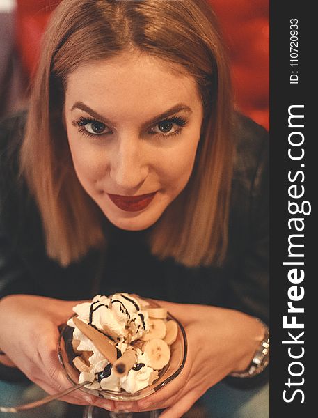 Woman Looking on Camera Holding Bowl With Ice Cream