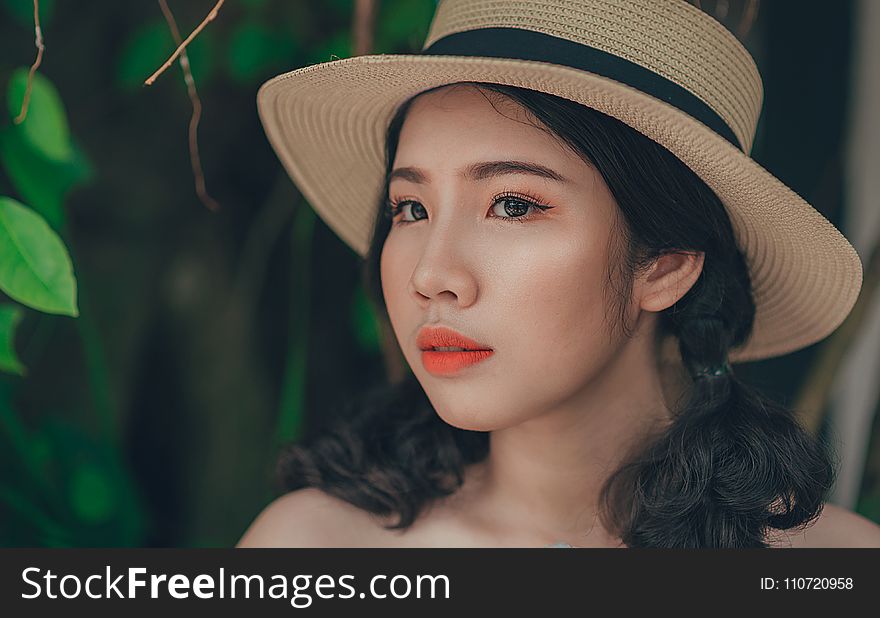 Woman With Pony-tailed Hair Wearing Brown And Blue Straw Hat