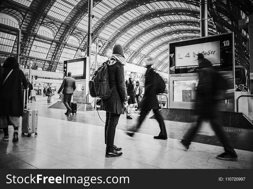 Time Lapse Grayscale Photograph of People Pass Through Inside Transportation Terminal