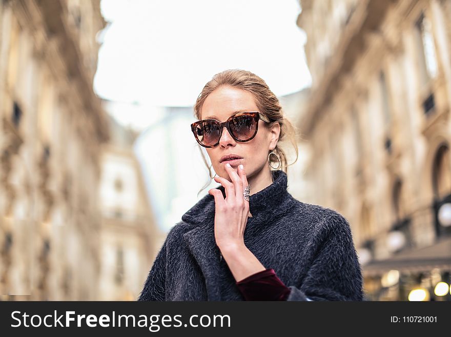 Woman Wearing Black Coat and Brown Framed Sunglasses