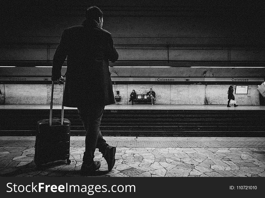 Man With Luggage Bag on Train Station