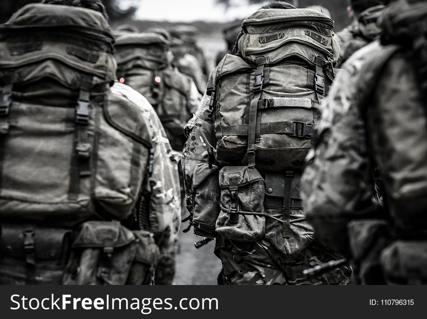 Group Of People With Camouflage Backpack