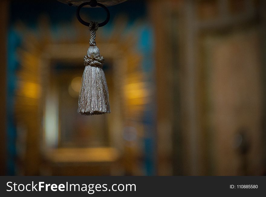 Selective Focus Photograph Of Gray Tassel Accessory