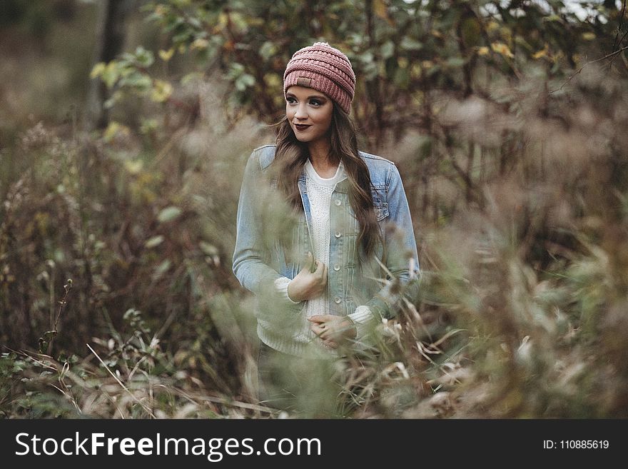 Woman Wearing Denim Jacket Near Trees and Bush