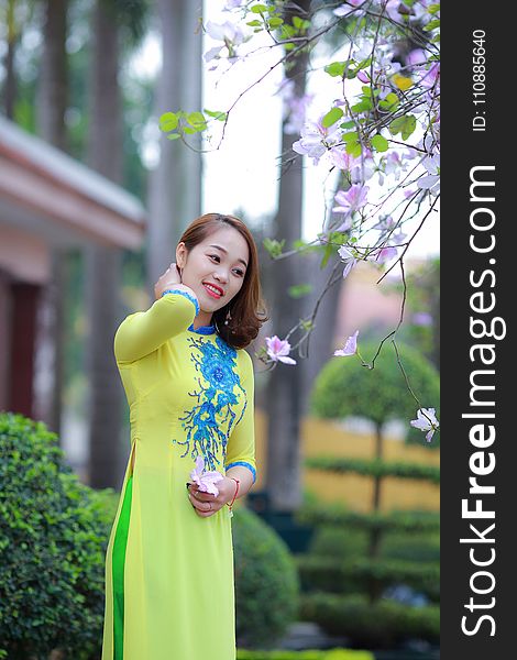 Photo of Woman Wearing Yellow and Blue Floral 3/4-sleeved Dress