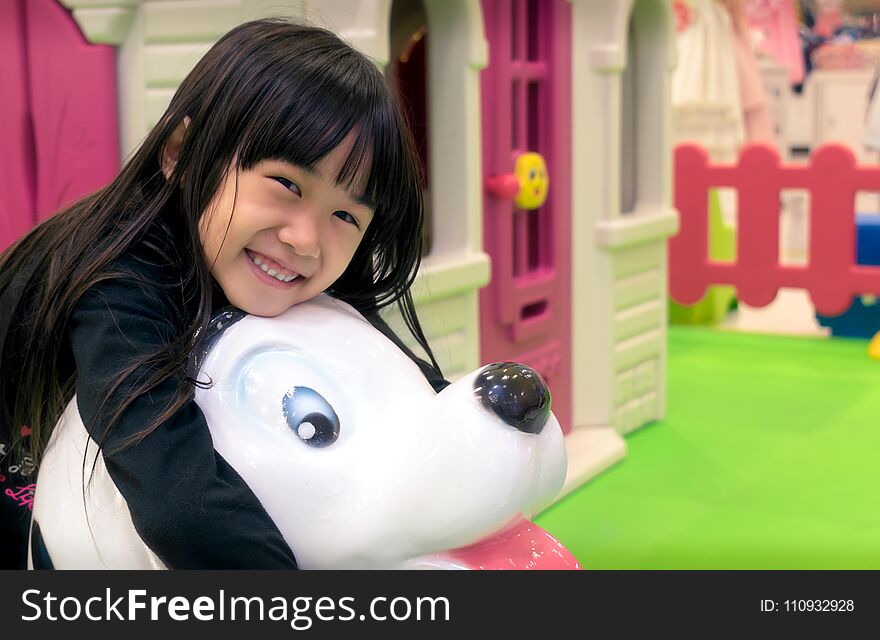 Asian Little Girl Plays in a Indoor Playground.