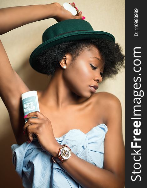 Woman Wearing Blue Strapless Dress Holding White And Gray Plastic Bottle