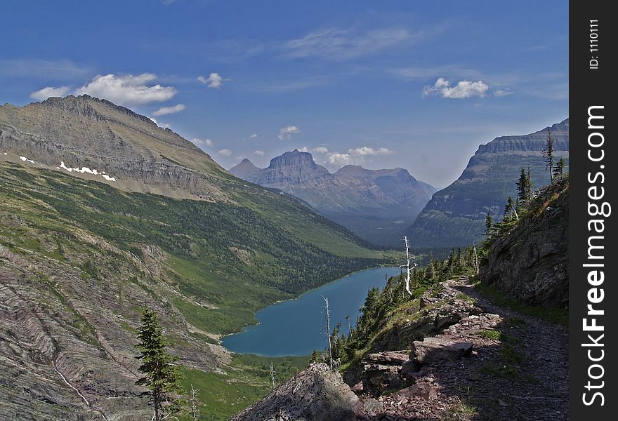 This image of the Gunsight Lake, mountains and the trail was taken on a recent hike in Glacier National Park. This image of the Gunsight Lake, mountains and the trail was taken on a recent hike in Glacier National Park.