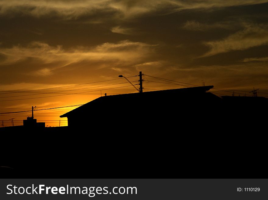 Sunset behind a house