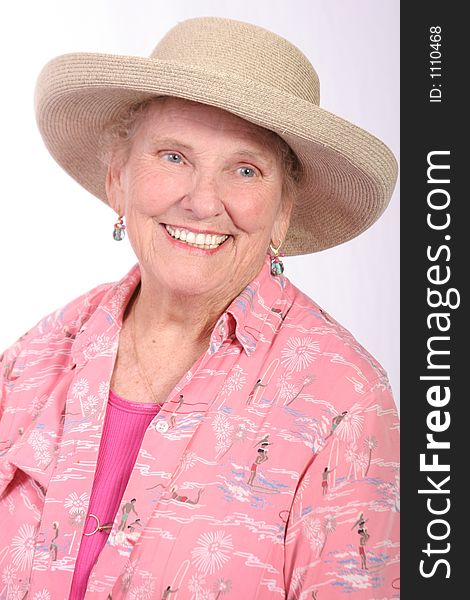 Senior women in a sun hat dressed in beach attire. Senior women in a sun hat dressed in beach attire