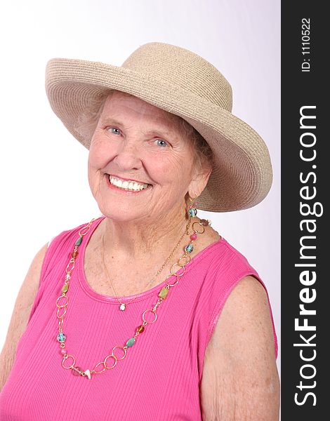 Smiling senior woman in a sun hat. Smiling senior woman in a sun hat