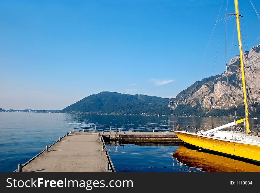Traunsee, a big lake in austria with a yellow boat. Traunsee, a big lake in austria with a yellow boat.