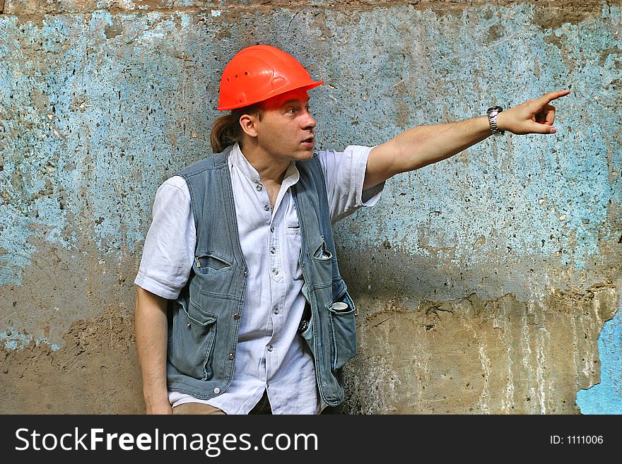 The main engineer on a background of an old wall.
The head in a red helmet a hand is lifted. The main engineer on a background of an old wall.
The head in a red helmet a hand is lifted