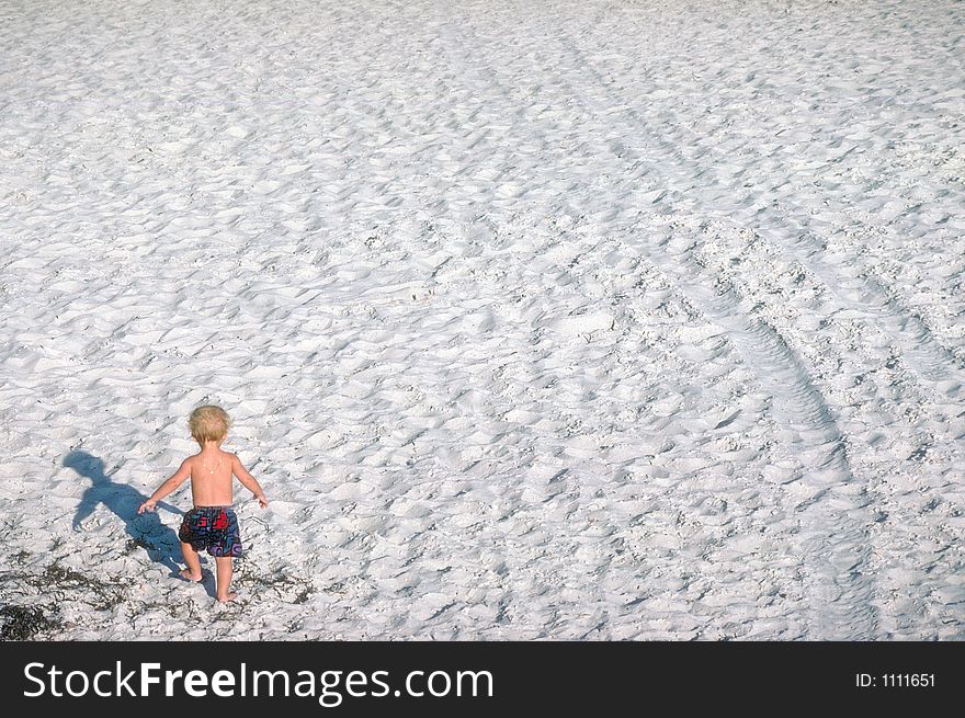 Small Boy Walking On Beach