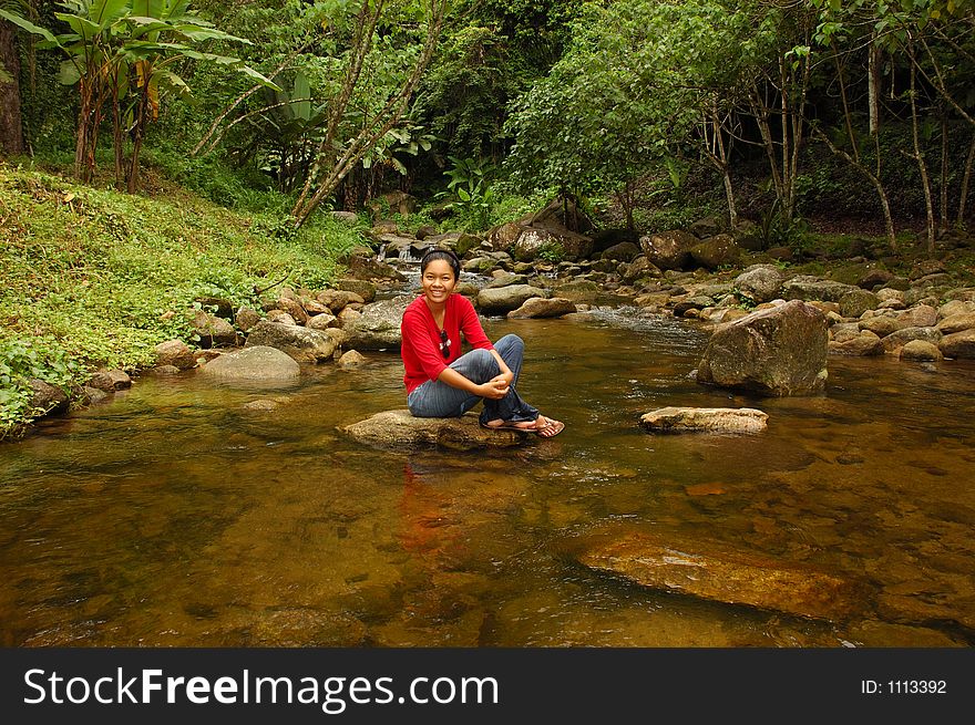 Relaxation! Girl with feet in stream.