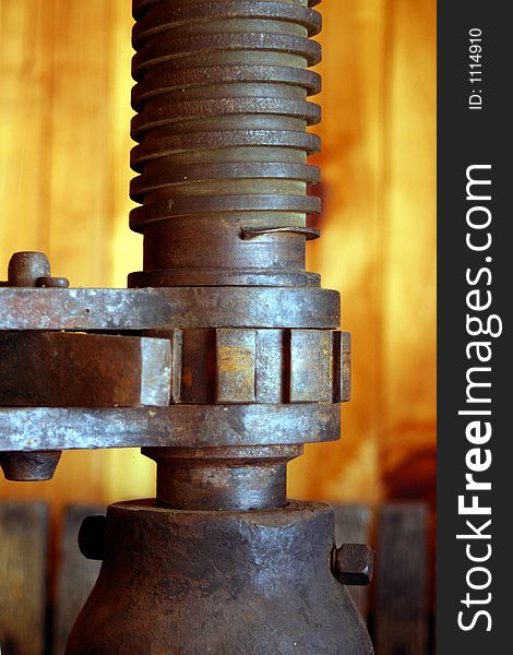 A close up of a antique cider press and gears. A close up of a antique cider press and gears