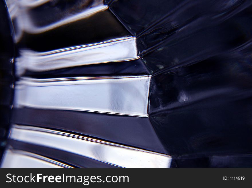 An abstract image of a cut piece of clear glass and how it refracts the light. An abstract image of a cut piece of clear glass and how it refracts the light.