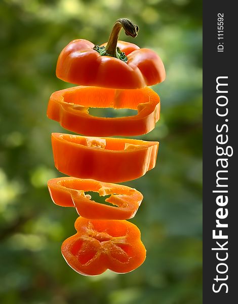 Flying sliced orange pepper