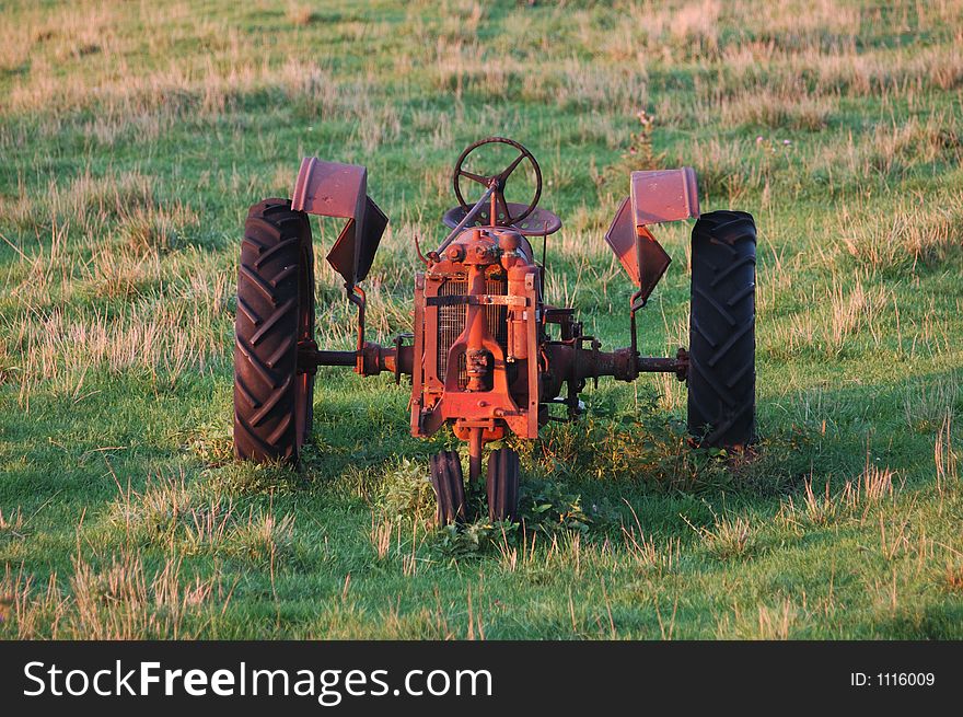 An antique tractor left to rust in a pasture in Iowa. An antique tractor left to rust in a pasture in Iowa.