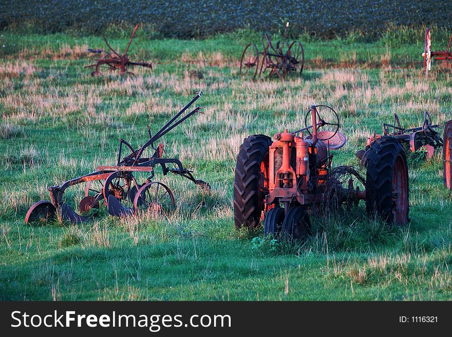 Antique tractors and farm equipment left to rust in a pasture in Iowa. Antique tractors and farm equipment left to rust in a pasture in Iowa.