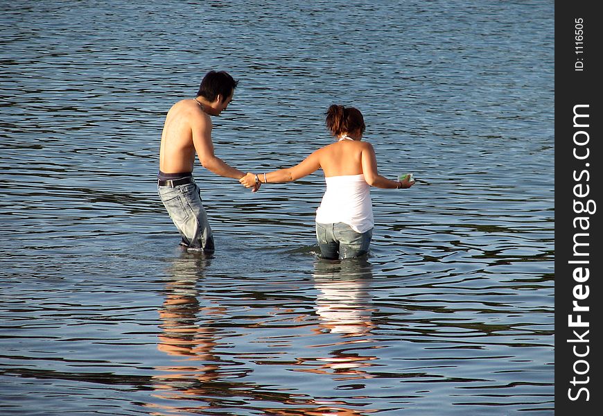 Couple playing in crystal clear water. Couple playing in crystal clear water.