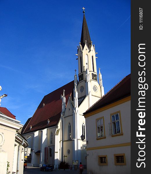 At the base of World Heritage Melk Abbey, in order to easily serve the inhabitants of the city, an regular church was erected recently. Under the blue sky in the afternoon sun, depicting a typical Austrian landscape. At the base of World Heritage Melk Abbey, in order to easily serve the inhabitants of the city, an regular church was erected recently. Under the blue sky in the afternoon sun, depicting a typical Austrian landscape.