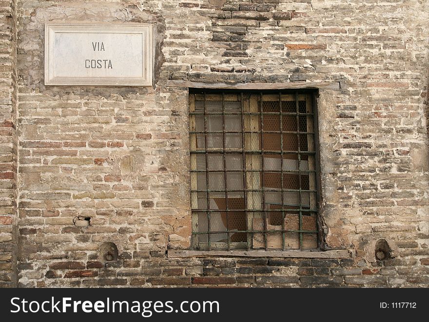 Barred old window in Via costa