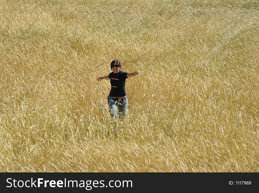 Woman running in wheat field