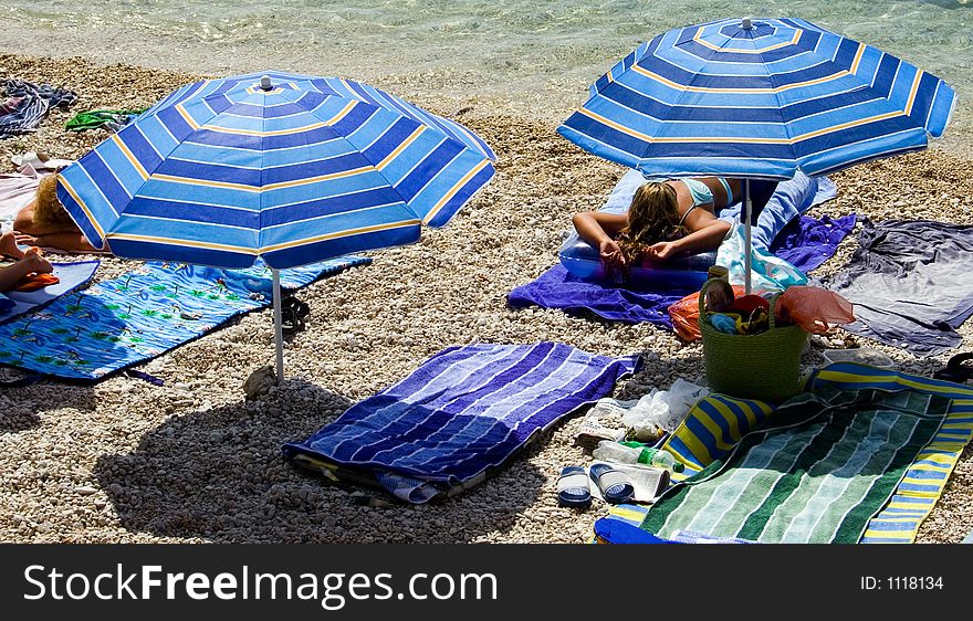 Beach details and a woman laying