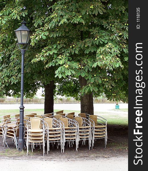 Chairs wait in the park restaurant for guests. Chairs wait in the park restaurant for guests