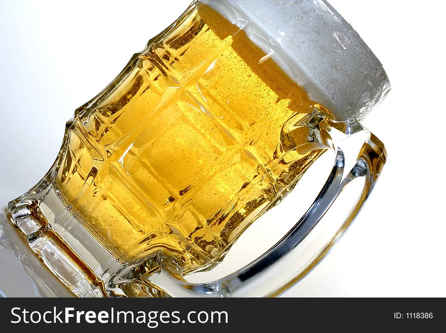 Isolated beer glass shot on an angle. Isolated beer glass shot on an angle.