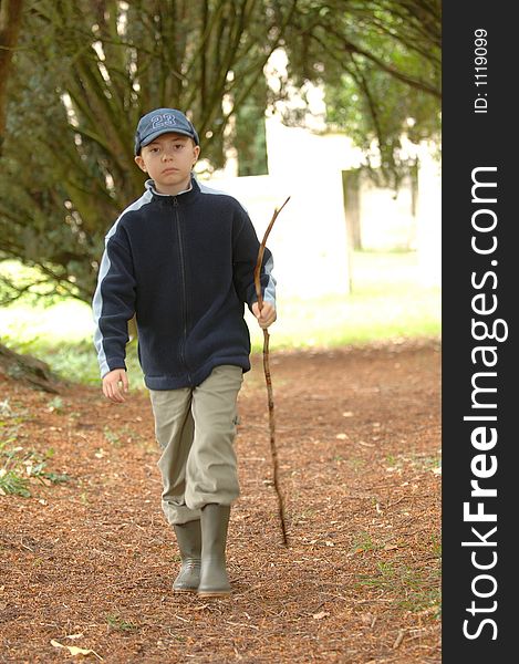 A boy walking in the park. A boy walking in the park