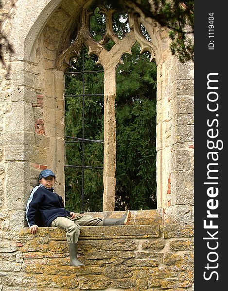 A boy relaxing in a window. A boy relaxing in a window