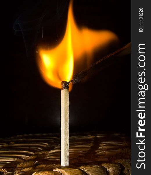 A macro photography of a burning match