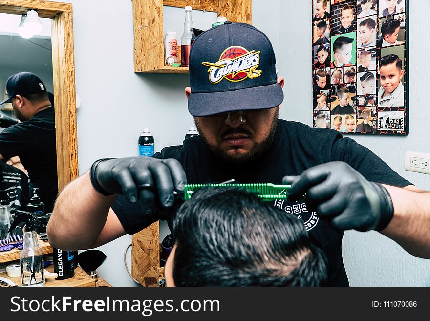 Closeup Photo of Man Wearing Black Shirt Holding Green Comb